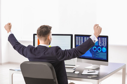 Male broker working in office. Finance trading concept