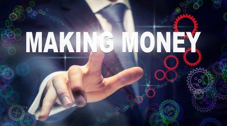 A businessman pressing a Making Money business concept on a graphical display of cogs